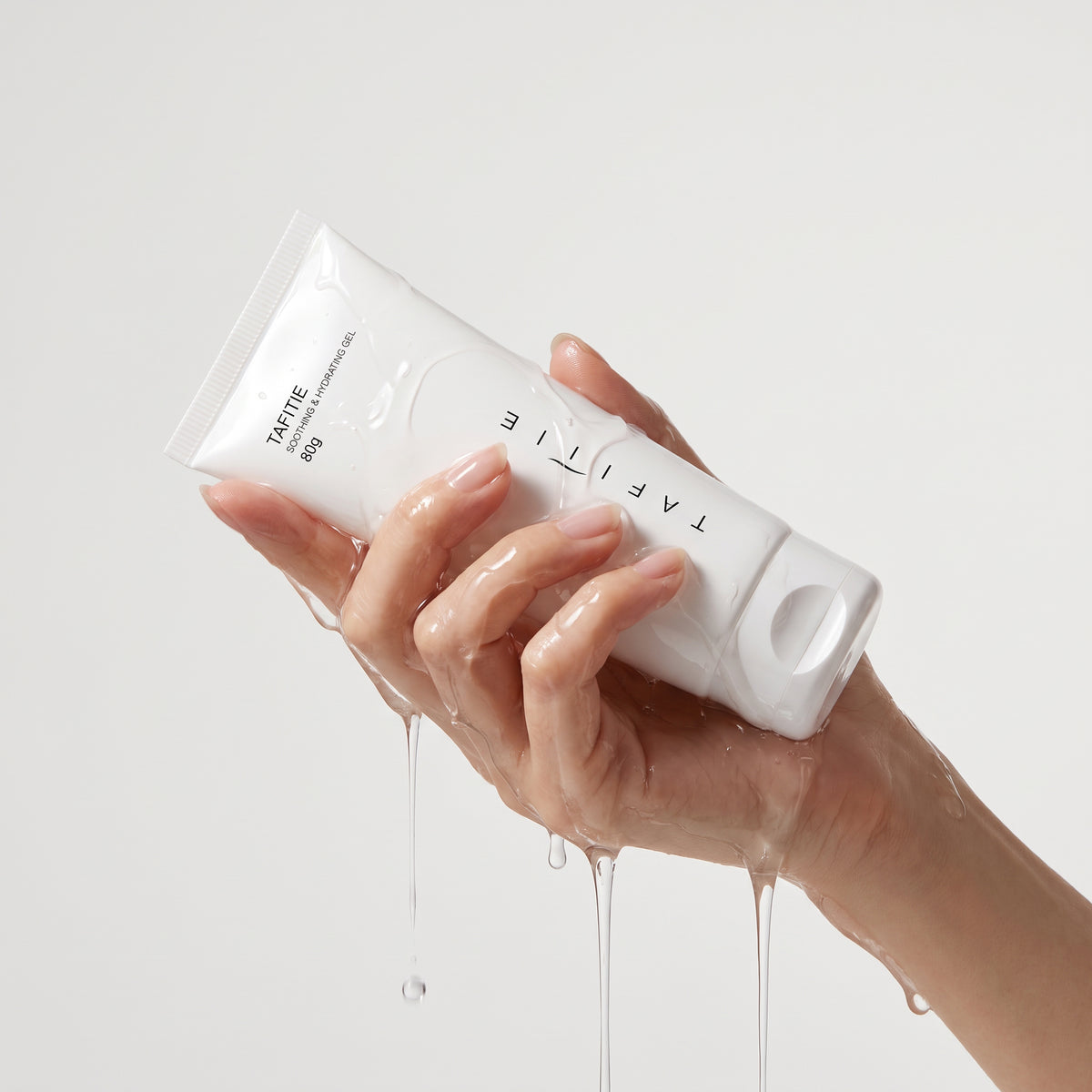 Hand squeezing TAFITIE ultrasound conductive gel tube with clear gel dripping