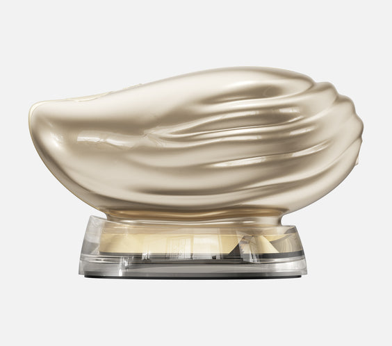 TAFITIE Conch shell-shaped facial device in gold on clear charging base, front view