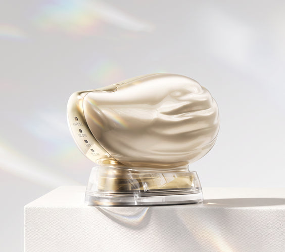 TAFITIE Conch facial device on charging base displayed on a white pedestal